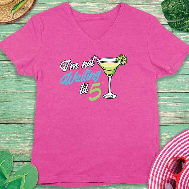 Pink t-shirt with a cocktail graphic and text on a wooden surface