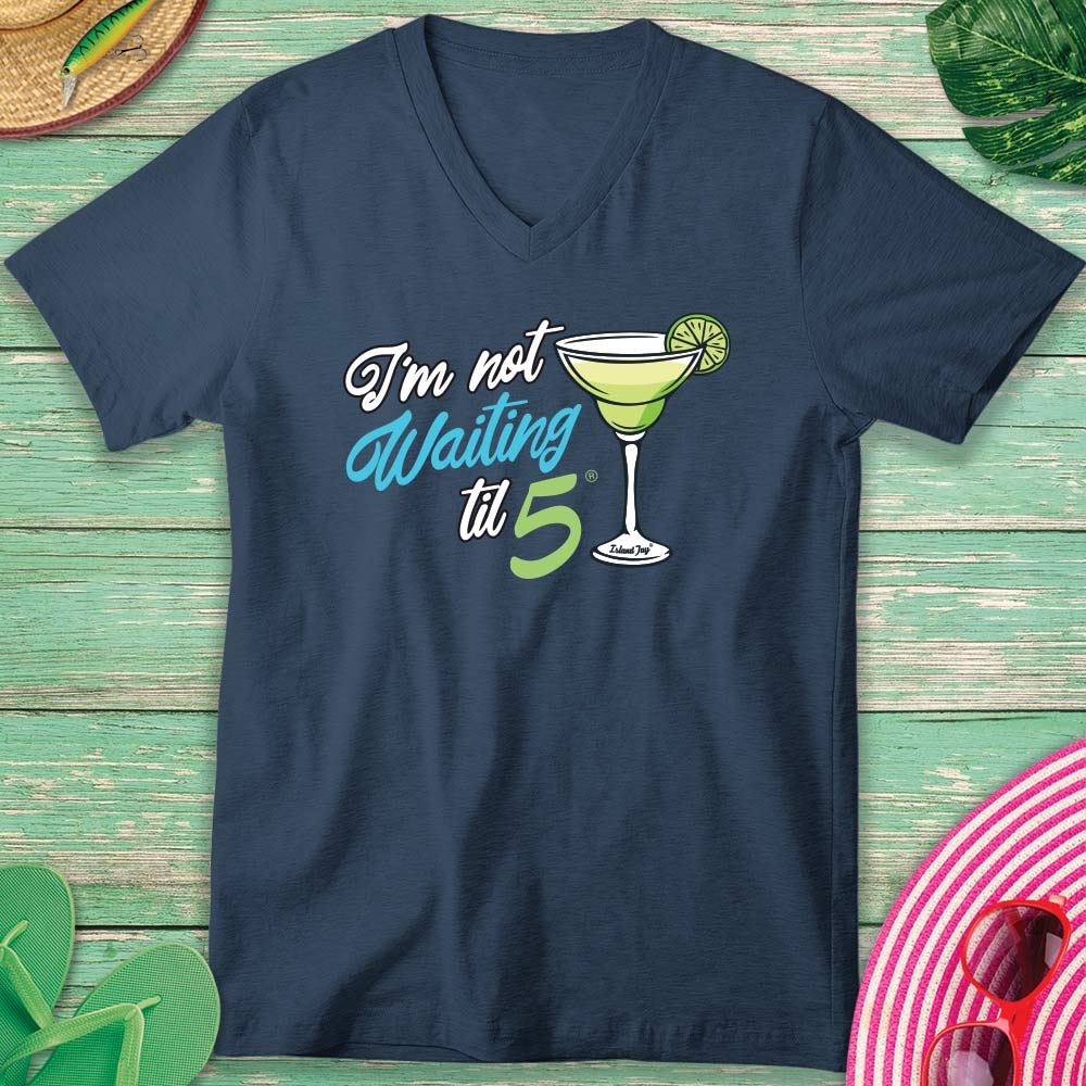 Navy blue t-shirt with a cocktail graphic and text on a wooden surface.