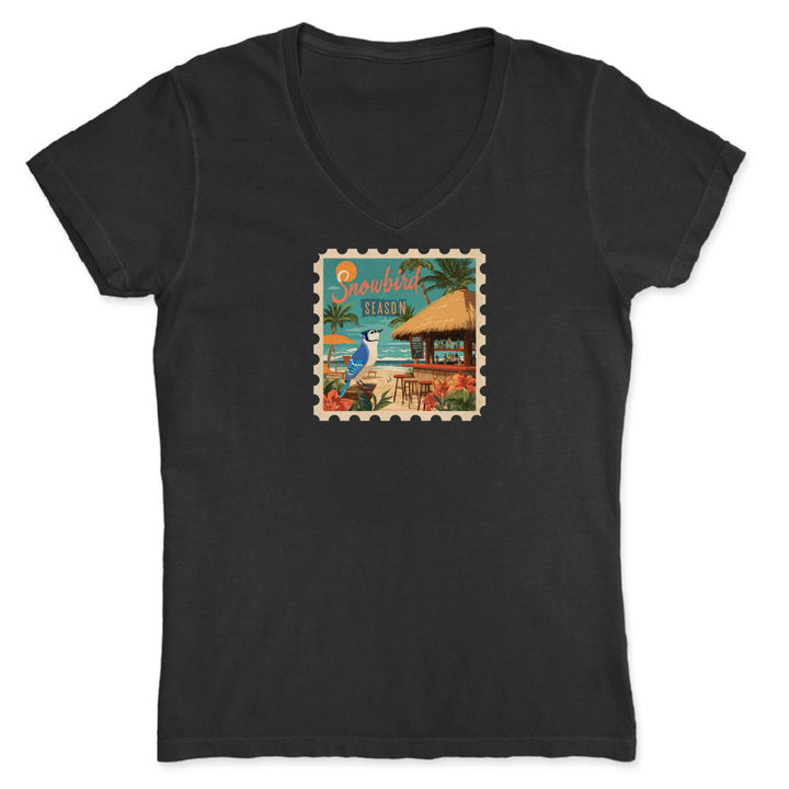 Black t-shirt with a tropical stamp design featuring a hut and beach scene on a white background.