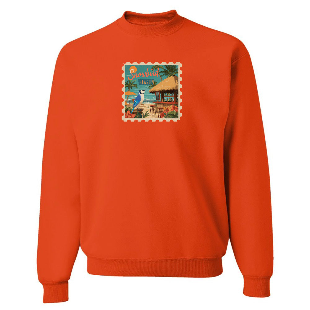Orange sweatshirt with a colorful graphic on a white background