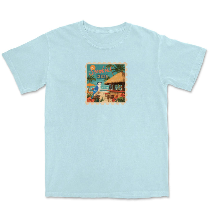 Light blue t-shirt with a tropical graphic on a white background