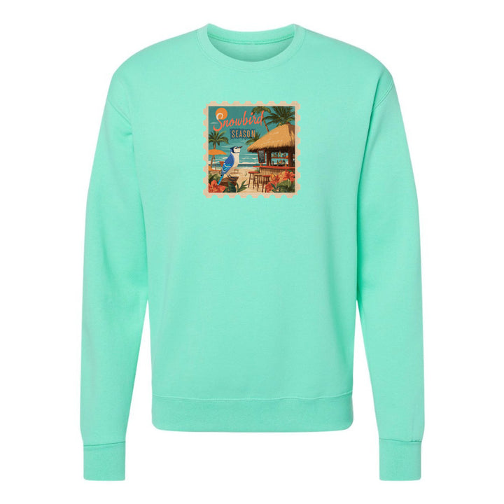 Mint green sweatshirt with a colorful graphic on a white background