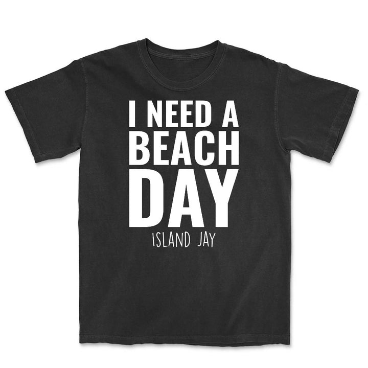 Black t-shirt with 'I Need a Beach Day' text on a white background