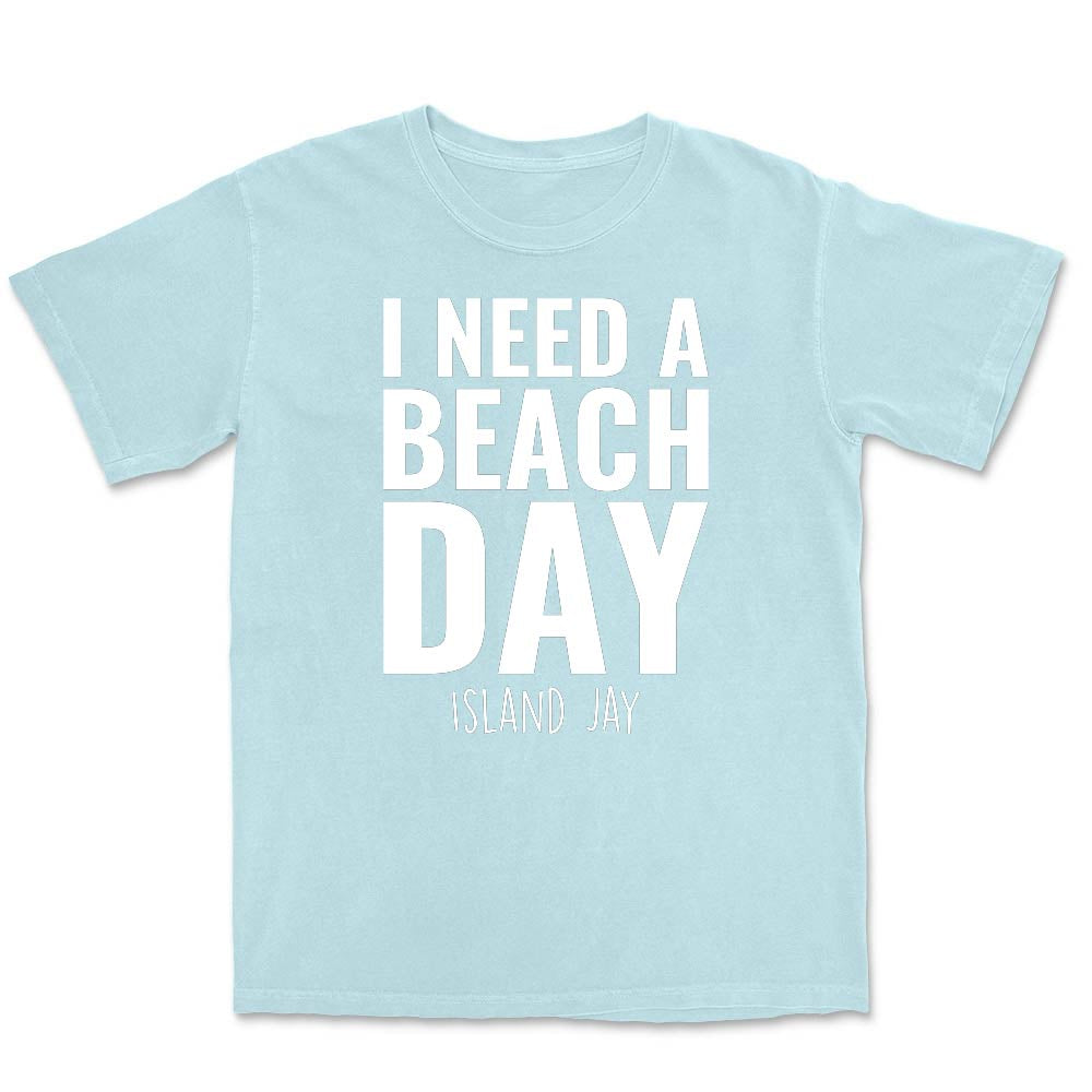 Light blue t-shirt with 'I Need a Beach Day' text on a white background