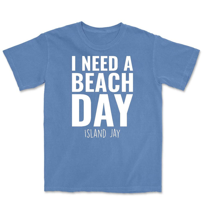 Blue t-shirt with 'I Need a Beach Day' text on a white background