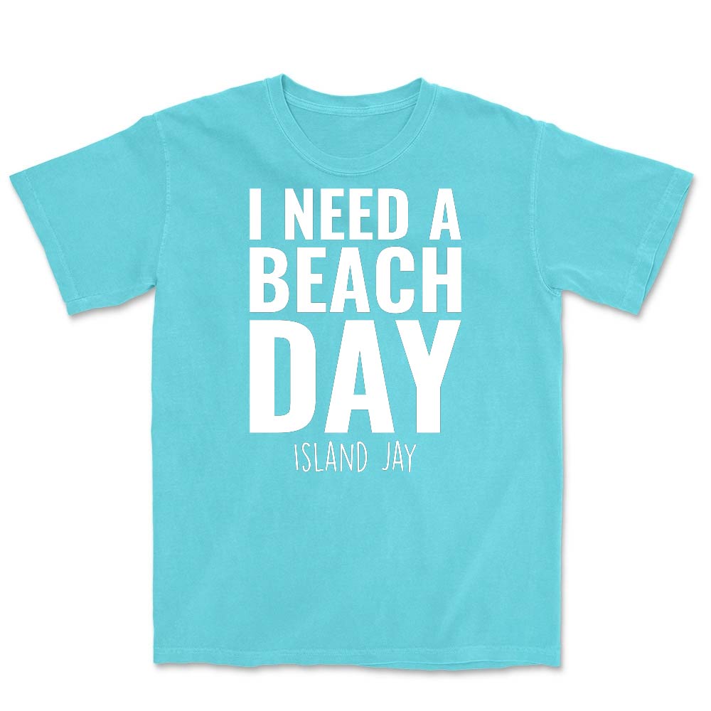 Light blue t-shirt with 'I NEED A BEACH DAY' text on a white background