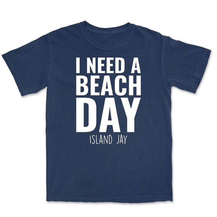 Navy blue t-shirt with 'I NEED A BEACH DAY' text on a white background