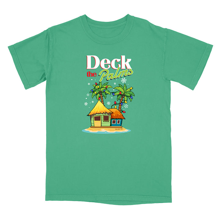Green t-shirt with a tropical hut and palm tree design with graphic text reading "Deck The Palms" on a white background