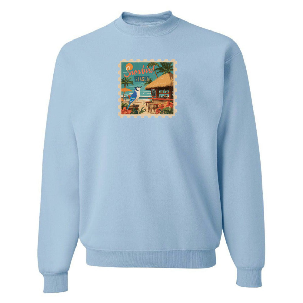 Light blue sweatshirt with a colorful graphic on a white background