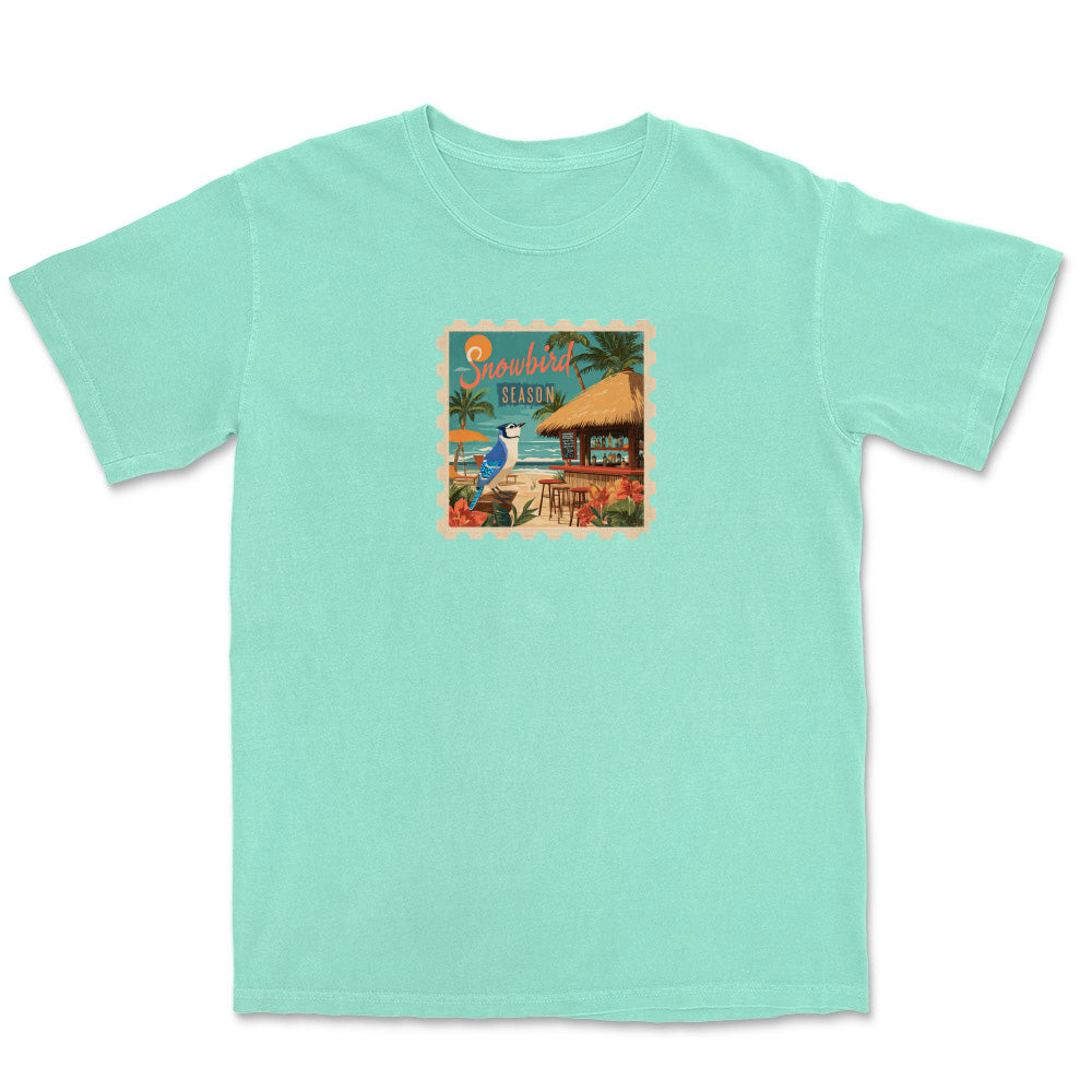 Mint green t-shirt with a tropical graphic on a white background