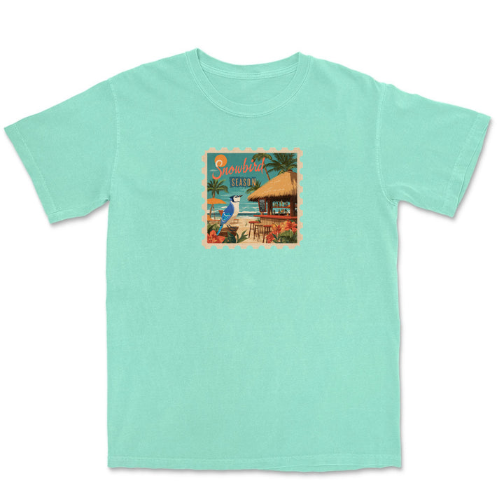 Mint green t-shirt with a tropical graphic on a white background