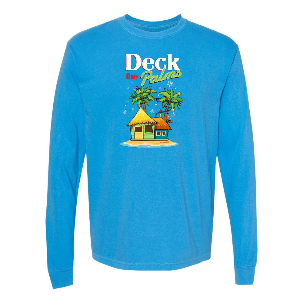 Blue long-sleeve shirt with a tropical hut and palm tree design and graphic text reading "Deck The Palms" on a white background