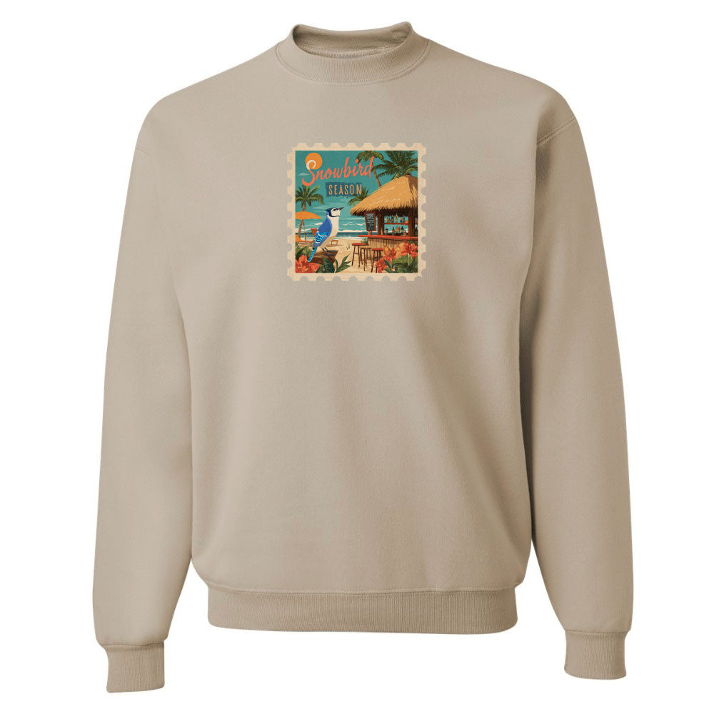 Beige sweatshirt with a colorful graphic on the chest against a white background