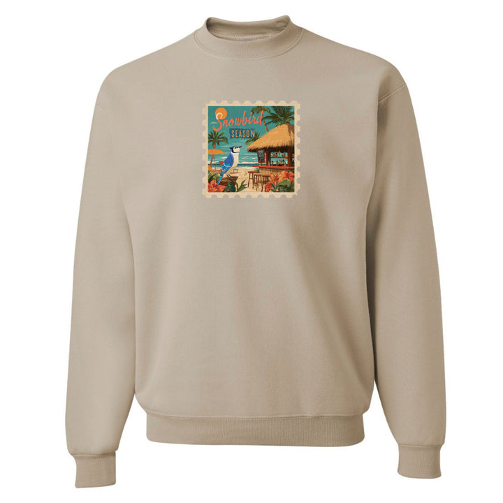 Beige sweatshirt with a colorful graphic on the chest against a white background