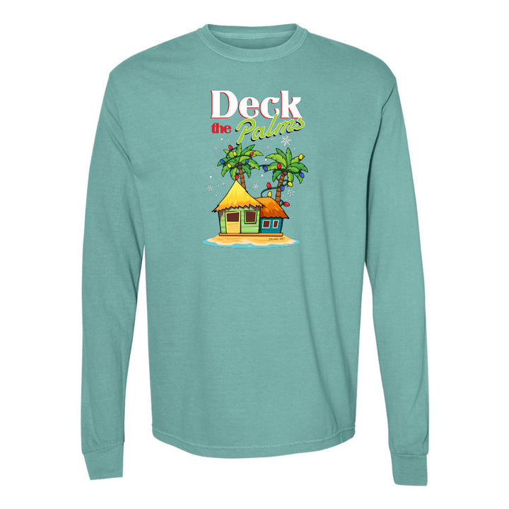 Teal long-sleeve shirt with a tropical hut and palm tree design and graphic text reading "Deck The Palms" on a white background