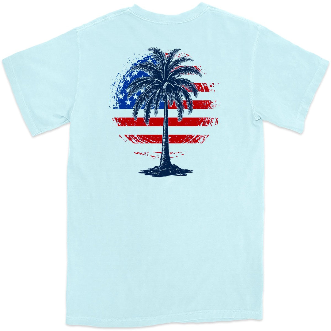 Freedom Shores T-Shirt. Am American Flag mixed with a tropical palm tree. Color Chambray Light Blue