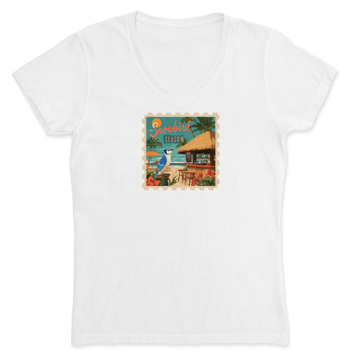 White t-shirt with a tropical graphic design featuring a hut and beach scene on a white background.