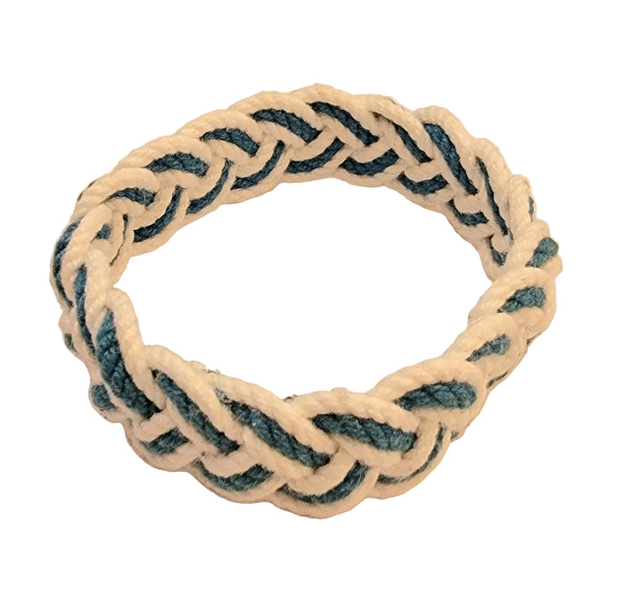 Nautical-style bracelet with braided design on a beige background