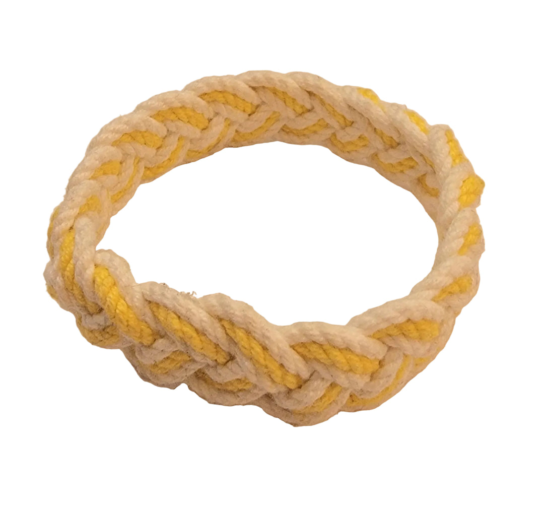 Nautical rope knot toy with yellow and white colors on a beige background