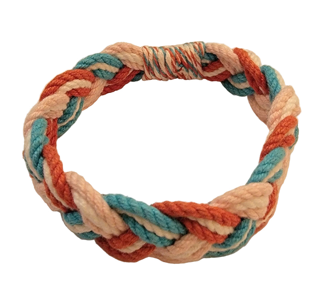 Multicolored braided rope on a beige background
