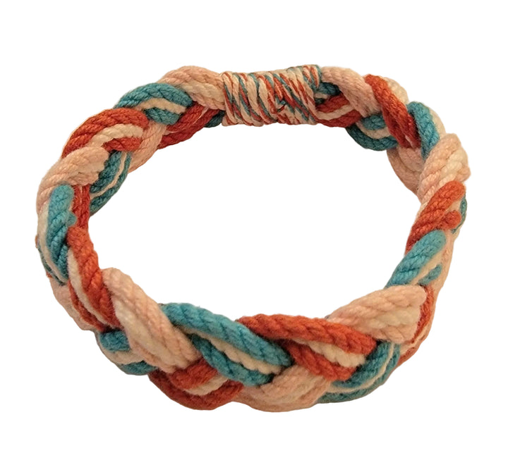 Multicolored braided rope on a beige background