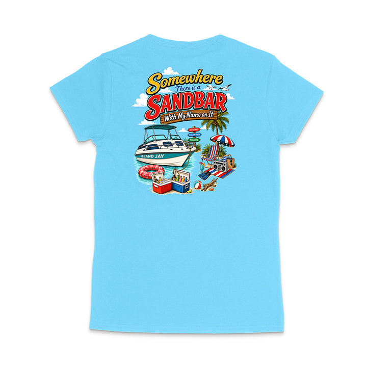 A light blue short-sleeve t-shirt shown from the back, featuring a colorful graphic print with the text 'Somewhere There Is A Sandbar With My Name on It' and beach-themed illustrations including a boat, umbrella, cooler, and palm tree.