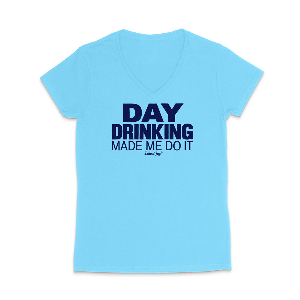 A light blue women's V-neck t-shirt with dark navy blue text on the front reading 'DAY DRINKING MADE ME DO IT' and a small 'Edible Joy' logo underneath, displayed on a clean white background.