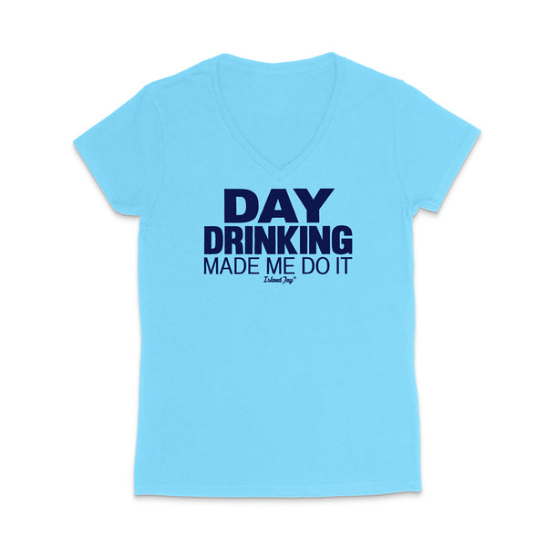 A light blue women's V-neck t-shirt with dark navy blue text on the front reading 'DAY DRINKING MADE ME DO IT' and a small 'Edible Joy' logo underneath, displayed on a clean white background.