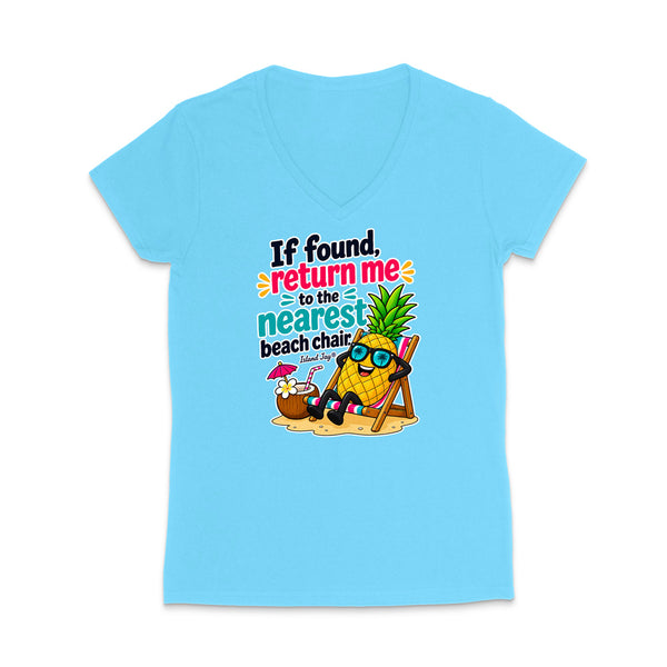 A light blue women's V-neck t-shirt with a colorful graphic on the front. The graphic features a pineapple character wearing sunglasses and sitting in a beach chair next to a coconut drink, with the text 'If found, return me to the nearest beach chair.