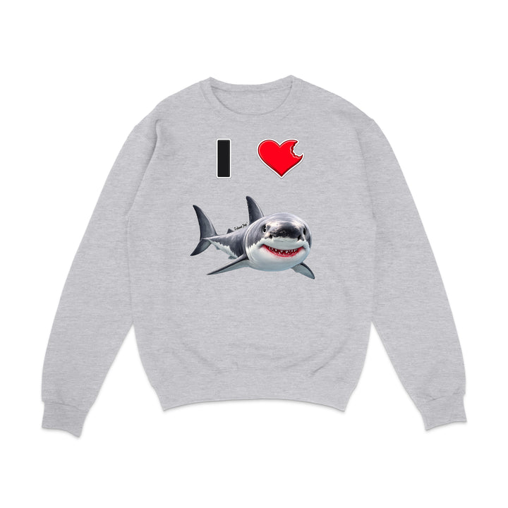 A light heather gray crewneck sweatshirt featuring a graphic print of a great white shark with its mouth open, accompanied by the text 'I' and a red heart emoji.