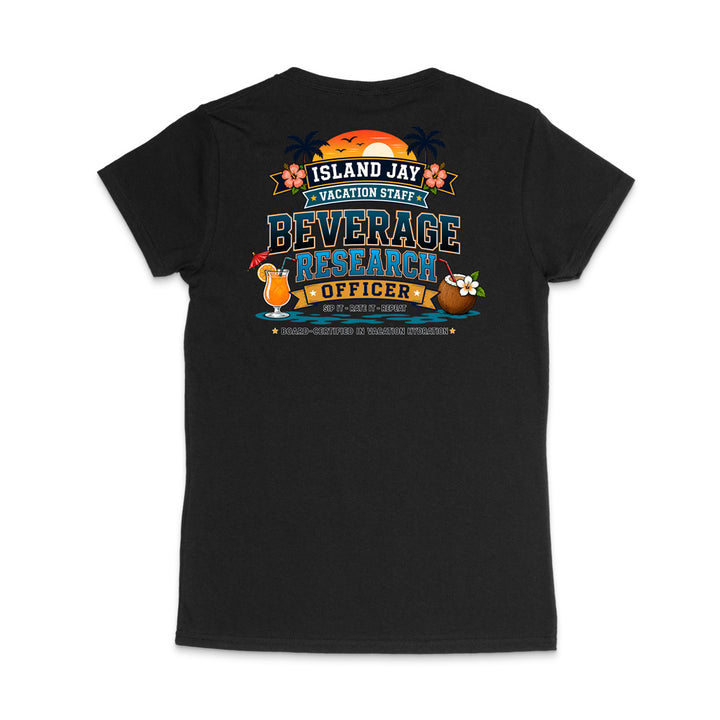 A black short-sleeve t-shirt shown from the back, featuring a colorful graphic print with tropical-themed text reading 'ISLAND JAY VACATION STAFF BEVERAGE RESEARCH OFFICER' and illustrations of a sunset, cocktail, coconut drink, and flowers.