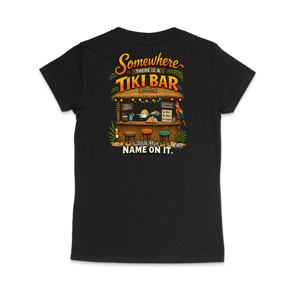 A black short-sleeve t-shirt shown from the back, featuring a colorful graphic print of a tropical 'Tiki Bar' with the text 'Somewhere there is a TIKI BAR' and 'With My NAME ON IT.'.