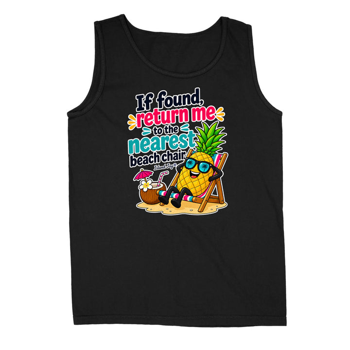 A black sleeveless tank top with a colorful graphic on the front showing a pineapple character wearing sunglasses and a beach chair next to a coconut drink, with the text 'If found, return me to the nearest beach chair' in playful multicolor lettering.