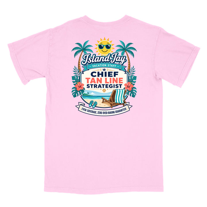 A pink short-sleeve t-shirt with a colorful graphic print on the front. The graphic features a smiling sun wearing sunglasses, palm trees, a beach scene, and text that reads 'Island Jay Vacation Staff by CHIEF TAN LINE STRATEGIST'.