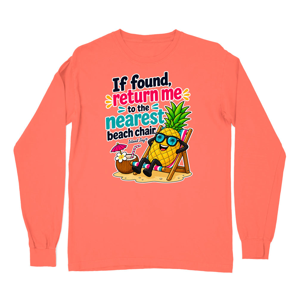 A coral orange long-sleeve t-shirt with a colorful graphic on the chest. The graphic features a cartoon pineapple wearing sunglasses and relaxing in a beach chair next to a coconut drink, with the text 'If found, return me to the nearest beach chair' and 'Tropical Pig'.