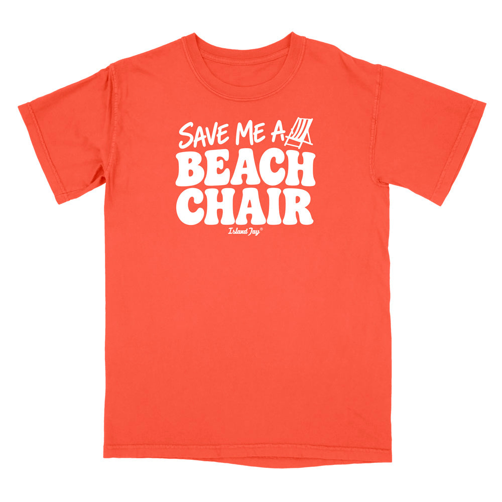 A bright salmon short-sleeve t-shirt with bold white text reading 'SAVE ME A BEACH CHAIR' 