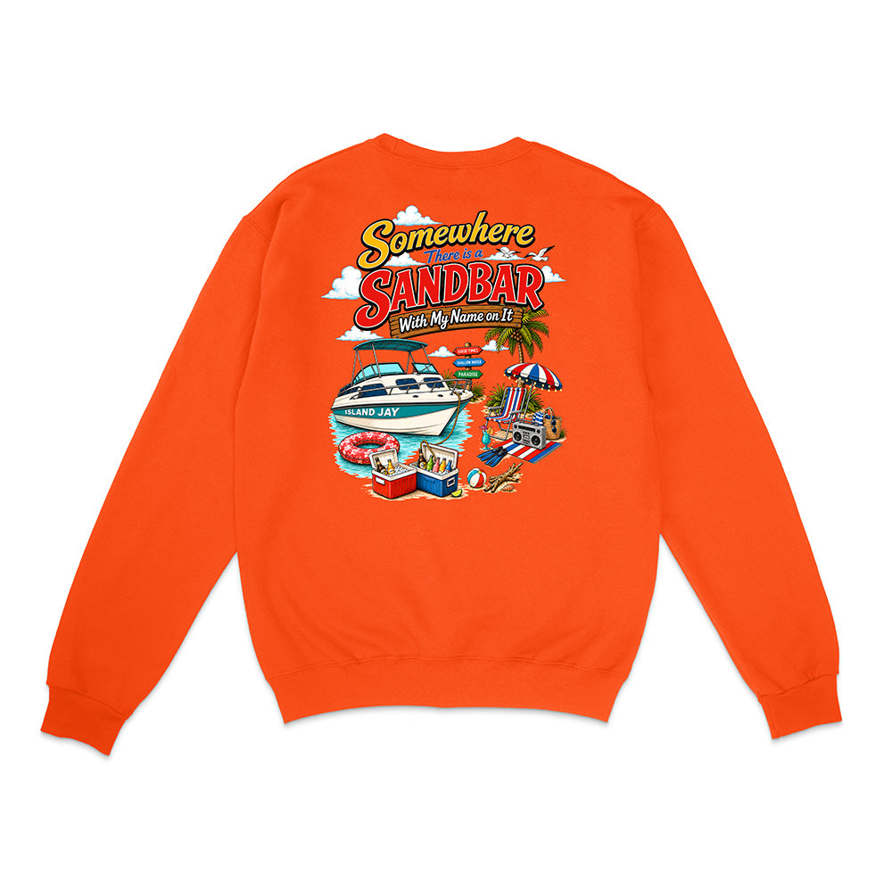 An orange crewneck sweatshirt shown from the back, featuring a colorful graphic print with the text 'Somewhere in the Sandbar' and illustrations of a boat, beach umbrella, and pool.