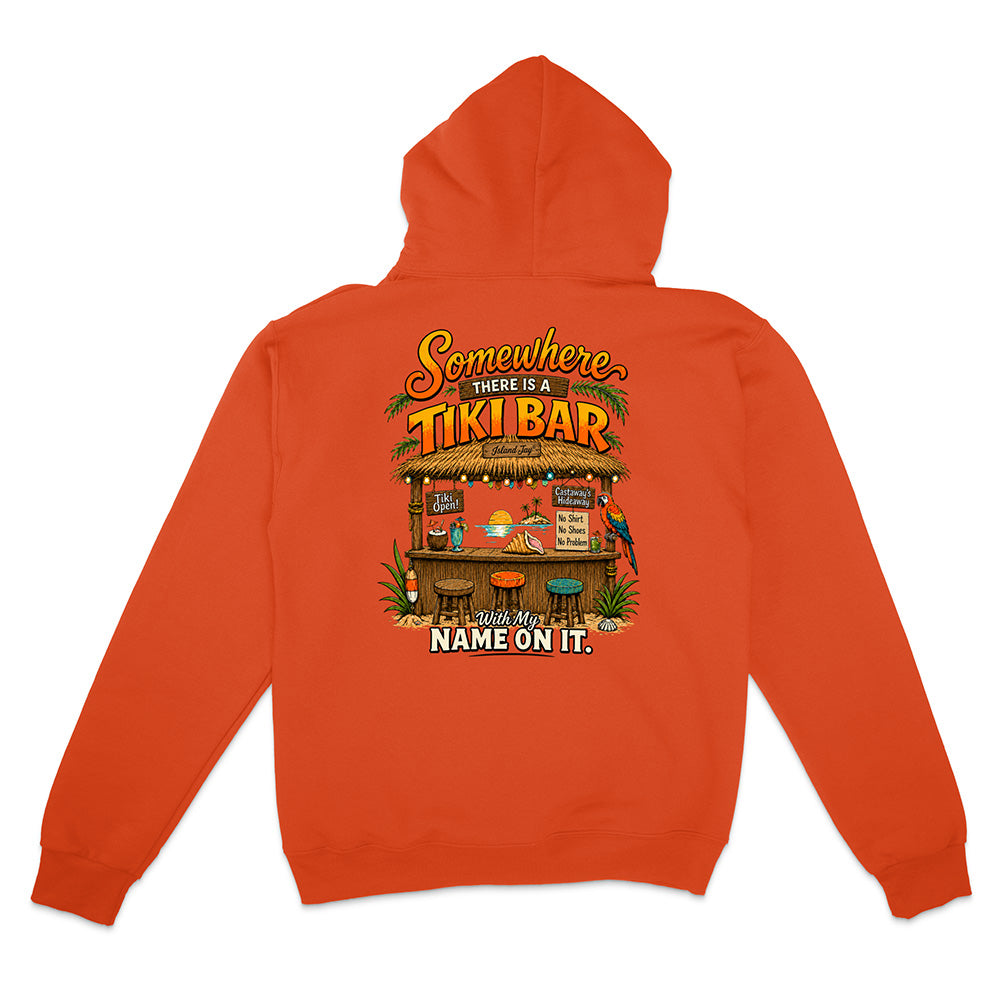 An orange hoodie shown from the back, featuring a colorful graphic of a tropical 'Tiki Bar' with the text 'Somewhere THERE IS A TIKI BAR' and 'NAME ON IT.'.