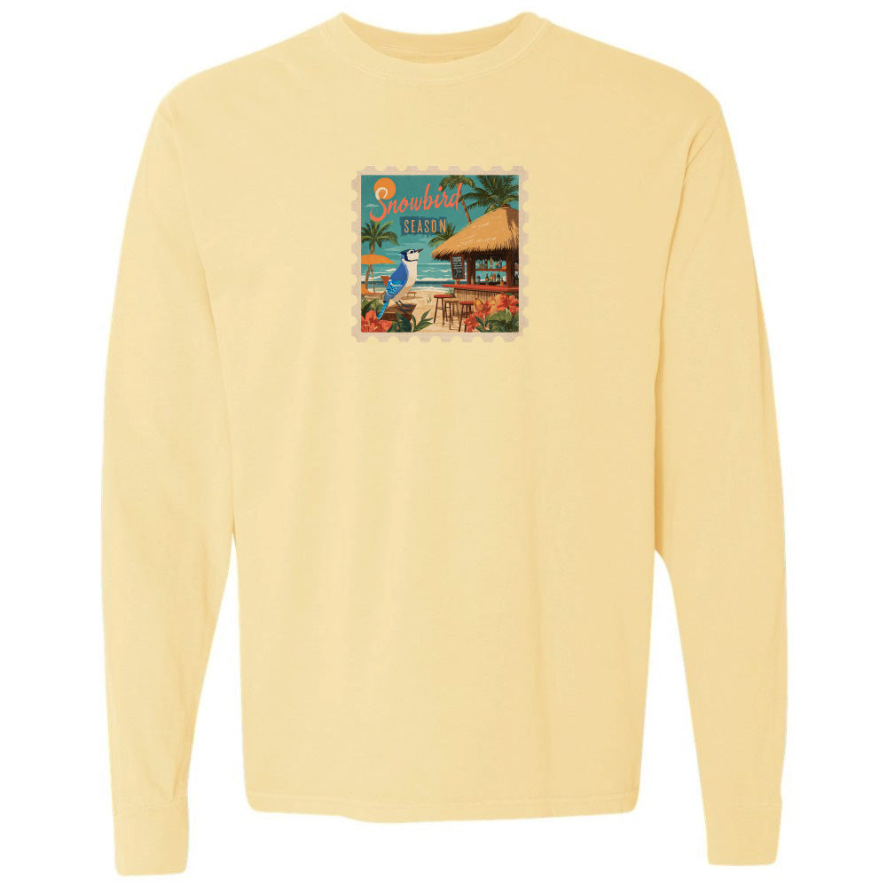 Yellow long-sleeve shirt with a colorful graphic on the chest against a white background