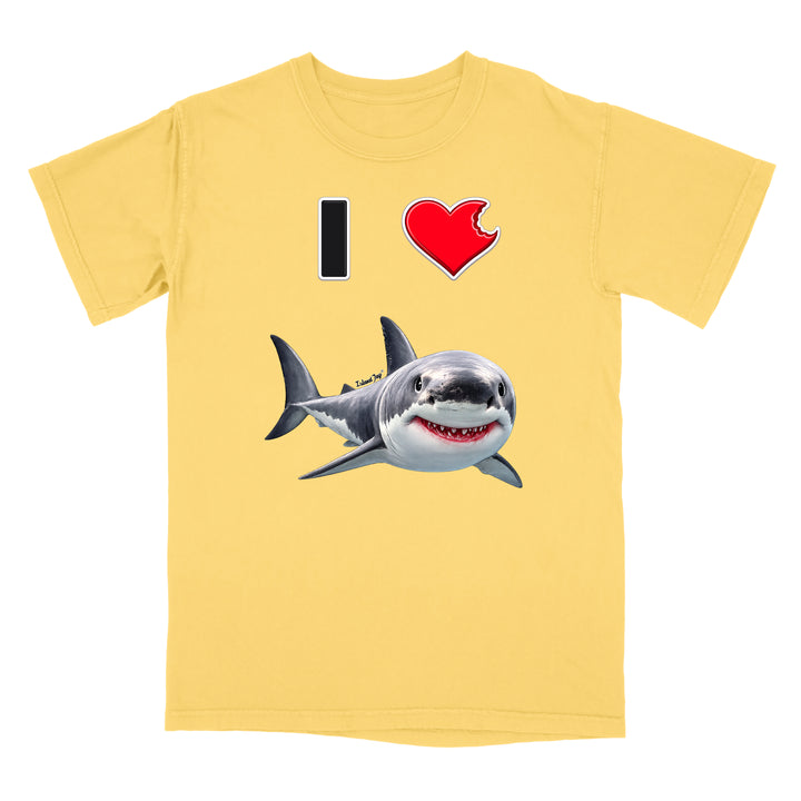 A pale yellow short-sleeve crewneck t-shirt featuring a graphic print of a great white shark and a red heart with a black 'I' on a white background.