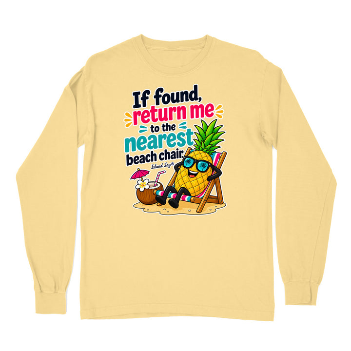 A pale yellow long-sleeve t-shirt with a colorful graphic of a pineapple wearing sunglasses and relaxing in a beach chair next to a coconut drink, with the text 'If found, return me to the nearest beach chair.'.