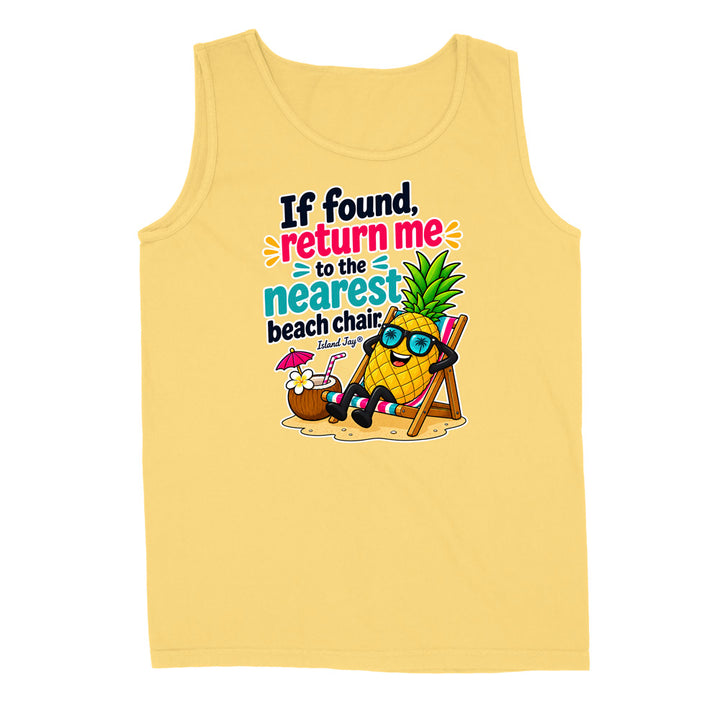 A pale yellow sleeveless tank top with a colorful graphic of a pineapple character wearing sunglasses and reclining in a beach chair, next to a coconut drink, with the text 'If found, return me to the nearest beach chair' and 'Island Style' printed on the front.