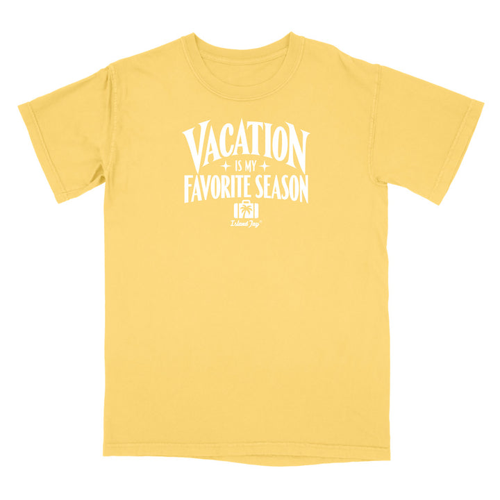 A yellow short-sleeve crewneck t-shirt with a white graphic print on the front that reads 'VACATION IS MY FAVORITE SEASON' with a small 'DelmarSys' logo underneath, displayed on a solid white background.