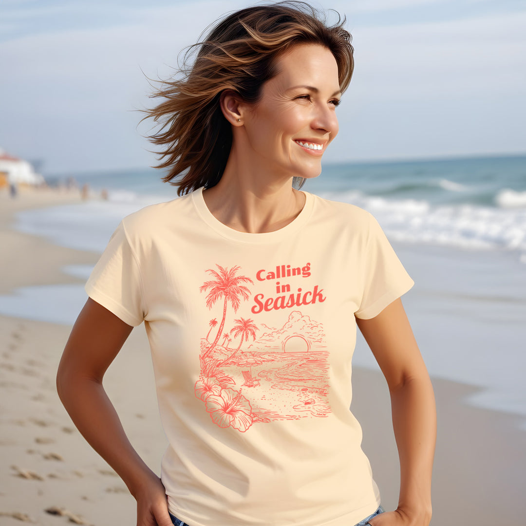 Calling In Seasick Funny Womens Tee. Shows a women wearing a soft and comfortable beach tee with calling in sick on it. THe shirt shows a beautiful beach scene. Color Peachy