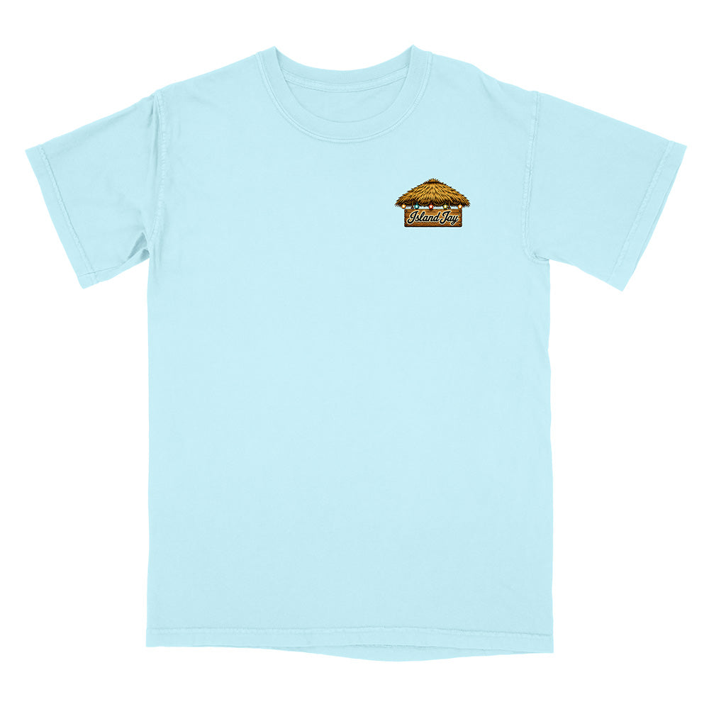 A light blue short-sleeve crewneck t-shirt with a small graphic on the left chest depicting a beach cabana with the word 'Mukilteo' written on it, shown against a plain white background.