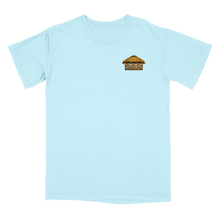 A light blue short-sleeve crewneck t-shirt with a small graphic on the left chest depicting a beach cabana with the word 'Mukilteo' written on it, shown against a plain white background.