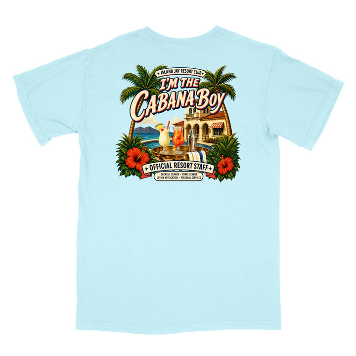 A light blue short-sleeve t-shirt shown flat against a white background, featuring a large, colorful graphic print on the back with tropical palm trees, hibiscus flowers, a resort building, and the text 'I'm The Cabana Boy' and 'Official Resort Staff'.