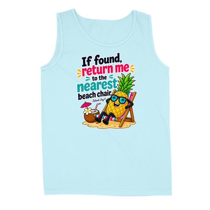 A light blue sleeveless tank top with a colorful graphic print on the front. The graphic features a cartoon pineapple wearing sunglasses and reclining in a beach chair next to a coconut drink, with the text 'If found, return me to the nearest beach chair' and 'Island Surf'.