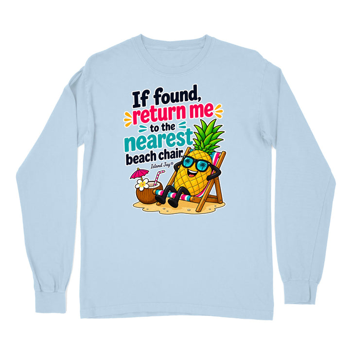 A light blue long-sleeve t-shirt with a colorful graphic print on the front. The graphic features a cartoon pineapple wearing sunglasses and relaxing in a beach chair next to a coconut drink, with the text 'If found, return me to the nearest beach chair' and 'Edward Jung's'.