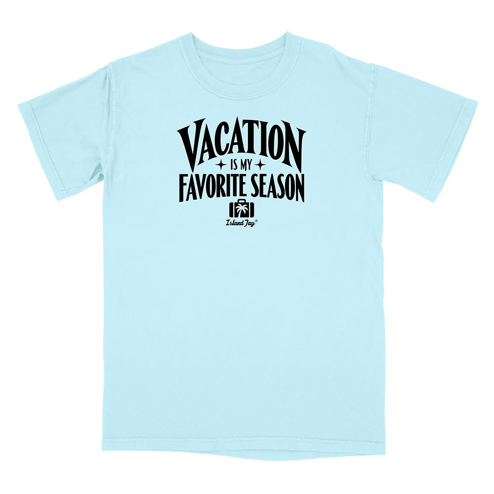 A light blue short-sleeve t-shirt with a black graphic print on the front that reads 'VACATION IS MY FAVORITE SEASON' with a small camera logo and 'Kalamaya' underneath, displayed on a clean white background.